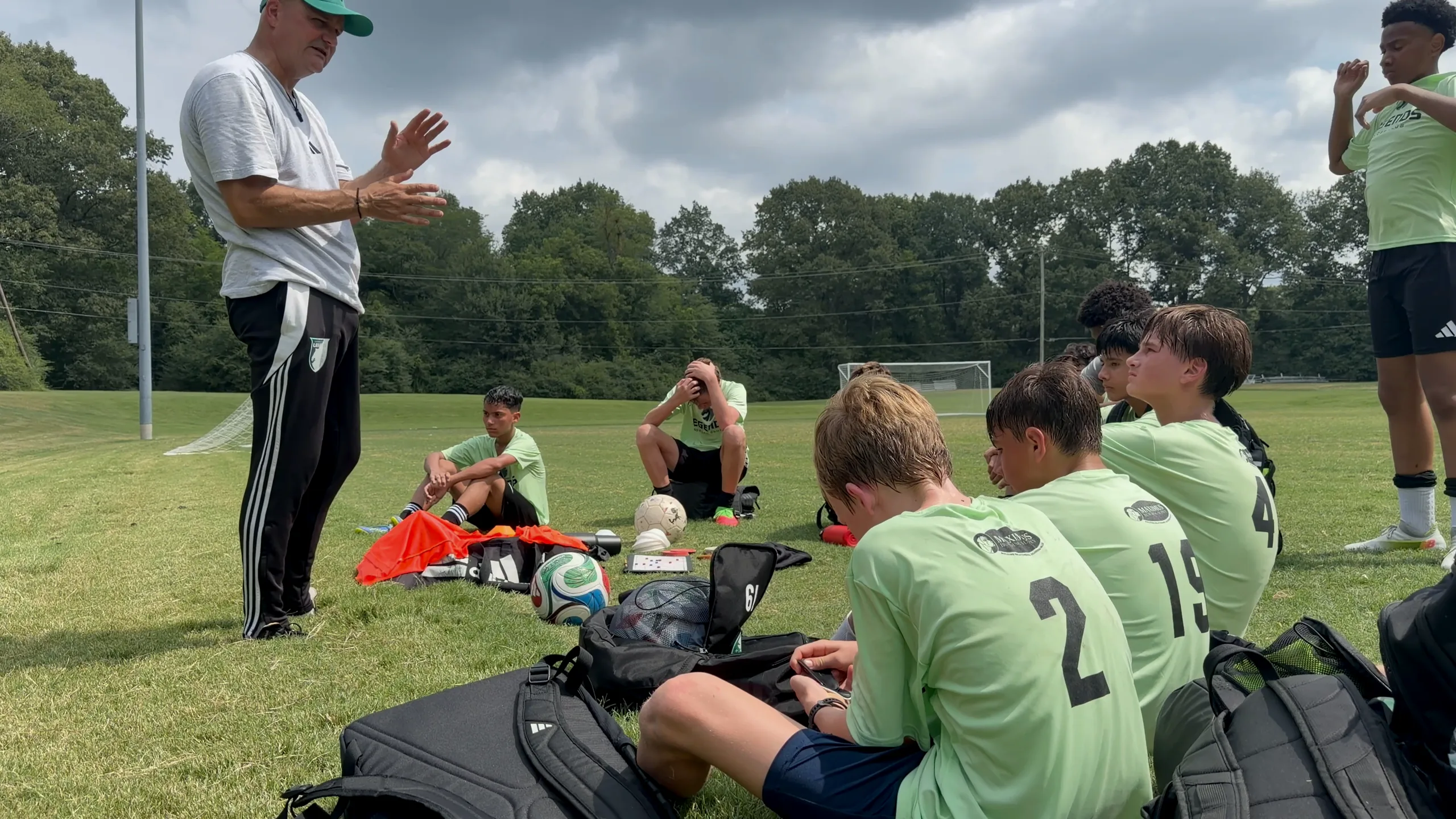 Germantown Legends players listen as their coach speaks on the field